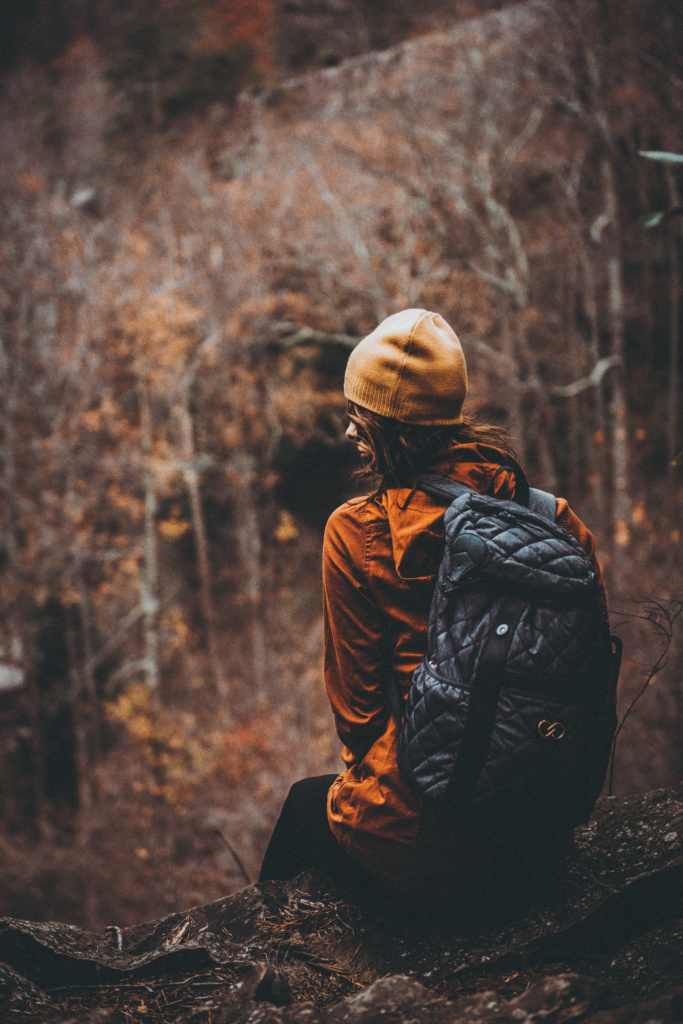 woman with backpack in woods